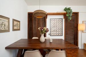 a dining room with a wooden table and chairs at KYMA by A&D Properties in Porto Rafti +8 photos