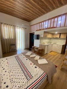 a large bed in a room with a kitchen at Pogradec Lake Apartments in Pogradec