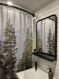 a bathroom with a sink and a window with trees at Mountain Stories Kazbegi-Stepantsminda in Kazbegi