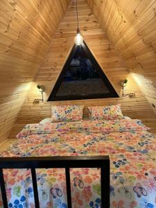 a bedroom with a bed in a wooden ceiling at Mountain Stories Kazbegi-Stepantsminda in Kazbegi