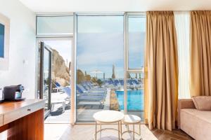 a living room with a view of a pool at Boutique Hotel Portofino in Odesa