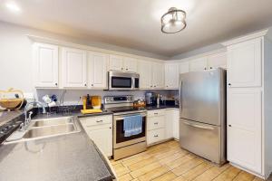 a kitchen with white cabinets and a stainless steel refrigerator at 37 Moonraker Road in Ocean Pines