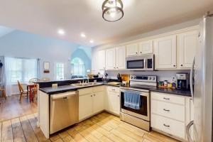a kitchen with white cabinets and white appliances at 37 Moonraker Road in Ocean Pines +14 photos