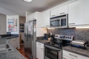 a kitchen with stainless steel appliances and white cabinets at 3017 Ocean Winds in Seabrook Island
