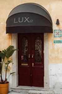 a front door of a building with a black awning at Villa Luxa in Sintra +29 photos