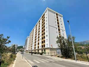 a tall white building on the side of a street at Alula Apartments 2 in Bar