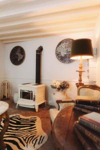 a living room with a fireplace and a couch and a table at Villa Luxa in Sintra