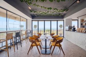 a restaurant with a table and chairs with a view at Senses Villa By PopDan in Vama Veche