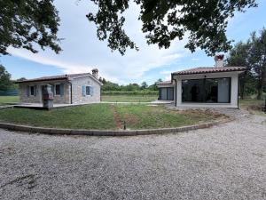 a house with a garden in front of it at House Avena with spa & gym in Labin