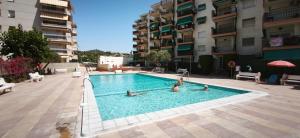 a group of people in a swimming pool in a building at CALAFELL 5 BEACH in Calafell