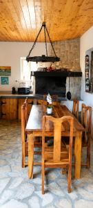 a wooden table and chairs in a kitchen at Holiday Home Kotulin in Pakoštane