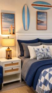 a bedroom with a bed and a night stand with a lamp at Beachfront Luxe, Ocean Views, Hot tub, Firepit, Sleeps 14 in Bolivar Peninsula
