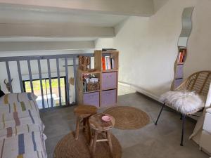 a room with a couch and a chair and a shelf at Corso di Mare Calvi in Calvi