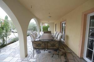 a porch with chairs and a table on a patio at Apartments REM-PIFRA in Novalja