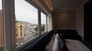 a living room with a couch and a large window at Palazzo Montella in Naples