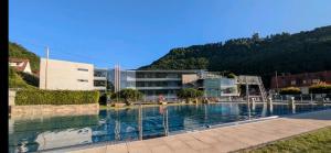 a large swimming pool in front of a building at Panoramablick Loft & Aktiv-Urlaub in Lichtenstein