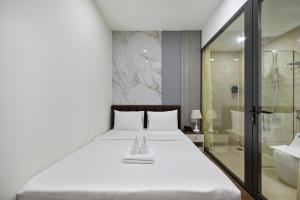 a bedroom with a white bed and a shower at The Crown Airport Hotel in Ho Chi Minh City +74 photos