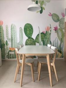 a table and chairs in a room with a cactus wall at Vera dream Las Marinas LAGUNA BEACH in Vera