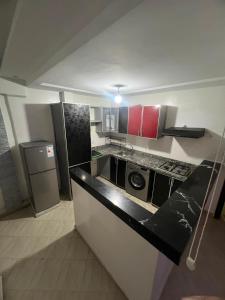 a kitchen with red cabinets and a counter top at la perle d'el jadida in El Jadida