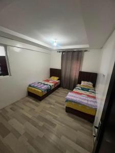 two twin beds in a room with at la perle d'el jadida in El Jadida +2 photos