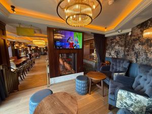 a bar with a couch and a table and a tv at Bayview Lodge in Downings