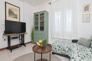 a living room with a tv and a couch at Brko's Place Sinj in Sinj