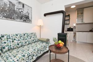 a living room with a couch and a bowl of fruit on a table at Brko's Place Sinj in Sinj