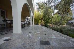 an outdoor patio with chairs and a table in a house at Apartments REM-PIFRA in Novalja