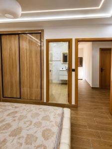 a bedroom with a bed and a living room at Les 3 perles in Ras El Ma
