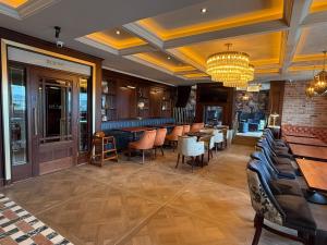 a restaurant with tables and chairs and a chandelier at Bayview Lodge in Downings