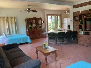 a living room with a couch and a table at Casitas Las Palmas - La Brisa in Punta Mita
