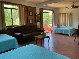 a living room with a couch and a bed at Casitas Las Palmas - La Brisa in Punta Mita
