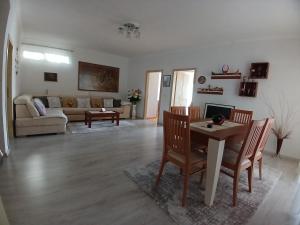 a living room with a table and chairs and a couch at EniGuesthouse in Gjirokastër