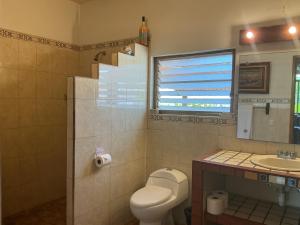 a bathroom with a toilet and a sink at Casitas Las Palmas - La Brisa in Punta Mita +37 photos