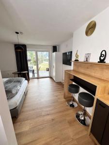 a bedroom with a bed and a desk with two stools at Grimming Lodge Tauplitz II in Tauplitz