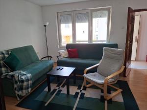 a living room with a couch and a chair and a table at Dama 1 in Bitola