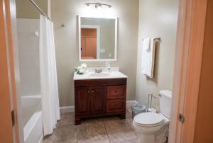 a bathroom with a sink and a toilet and a mirror at Ground Floor, 3BR Sleeps 8, Near Ingalls and Chevron -F- in Moss Point +15 photos