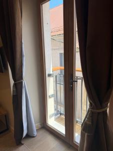 an open door with a view of a balcony at Le Col Getaway Virage 5 in Le Bourg-dʼOisans