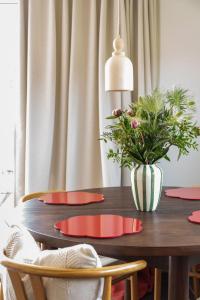 a dining room table with a vase of flowers on it at Vakantiewoning Conterdijk 13 in Koksijde