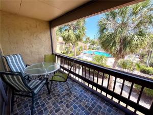 a balcony with a table and chairs and a large window at 1+1 Large condo Sarasota in Sarasota