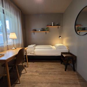a bedroom with a bed and a table and a desk at Akureyri Hostel in Akureyri +58 photos