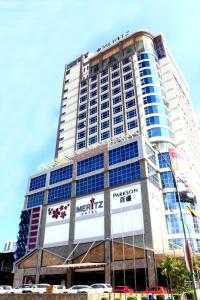 a tall building with a sign on the front of it at Meritz Hotel in Miri