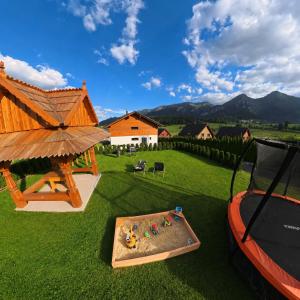 a backyard with a table and a gazebo at Apartmány Dominek in Ždiar