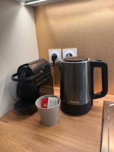 a coffee maker sitting on top of a counter at Le Col Getaway Virage 6 in Le Bourg-dʼOisans