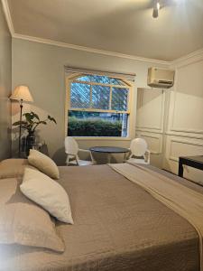 a bedroom with a large bed and a window at Mansão Morumbi 91 in São Paulo