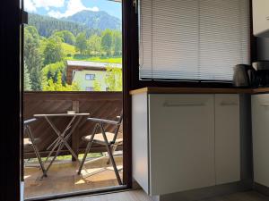a kitchen with a large window with a view of a mountain at Apartment Essreithweg Kaprun by Jara in Kaprun