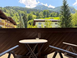 a table and chairs on a balcony with a view at Apartment Essreithweg Kaprun by Jara in Kaprun