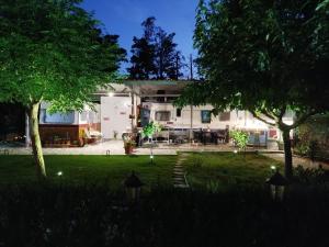 a house with a yard with trees and lights at DamAnda mare in Nea Potidaea
