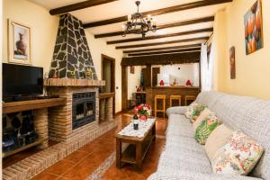 a living room with a couch and a fireplace at Villa Las Palomas 2 in Nerja