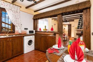 a kitchen with a sink and a washing machine at Villa Las Palomas 2 in Nerja
